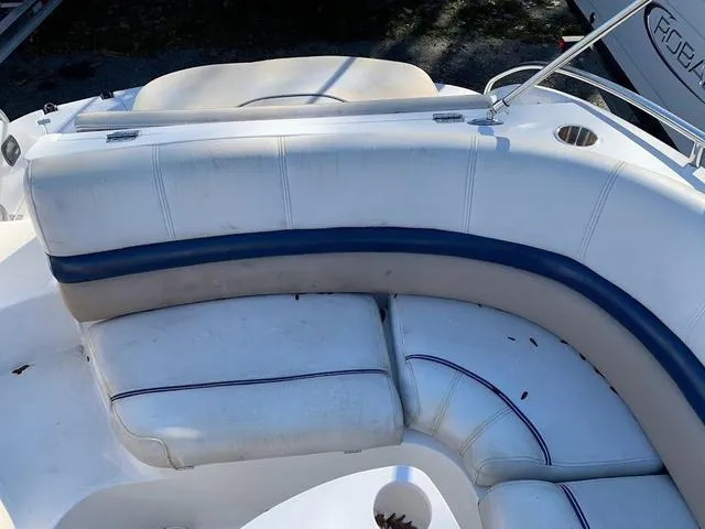 Slide: The Image of 2006 Hurricane 25' DC boat interior with white and blue seating. - 26