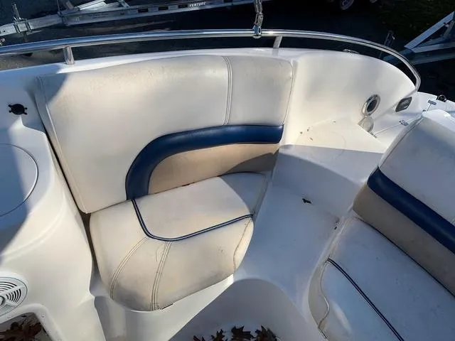 Slide: The Image of 2006 Hurricane 25' DC boat interior seating with white and blue upholstery. - 27