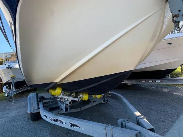 Slide: The Image of 2006 Hurricane 25' DC boat on Load Rite trailer, parked outdoors. - 5