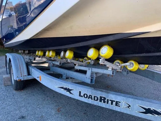 Slide: The Image of 2006 Hurricane 25' DC boat on LoadRite trailer with yellow rollers. - 7