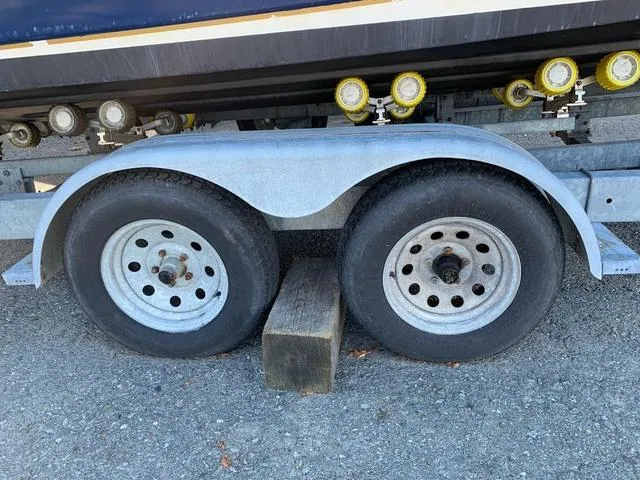 Slide: The Image of Trailer wheels of a 2006 Hurricane 25' DC boat on gravel. - 8
