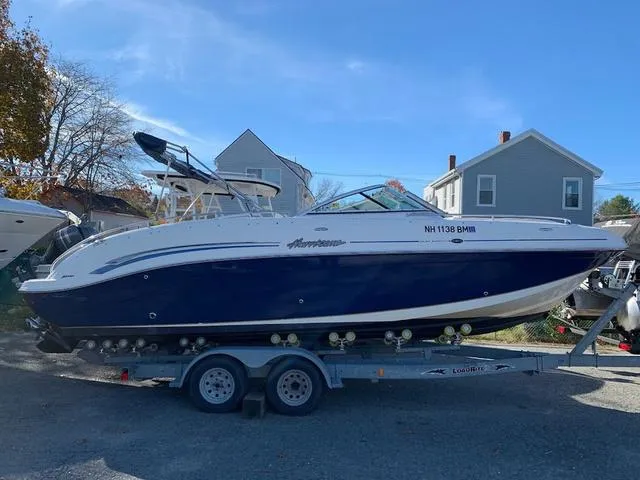 Slide: The Image of 2006 Hurricane 25' DC boat on trailer, parked outdoors. - 9