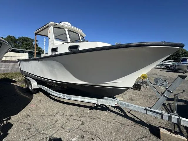 Slide: The Image of 1996 Eastern 27 Lobster Fisherman boat on trailer, white hull, parked outdoors. - 1