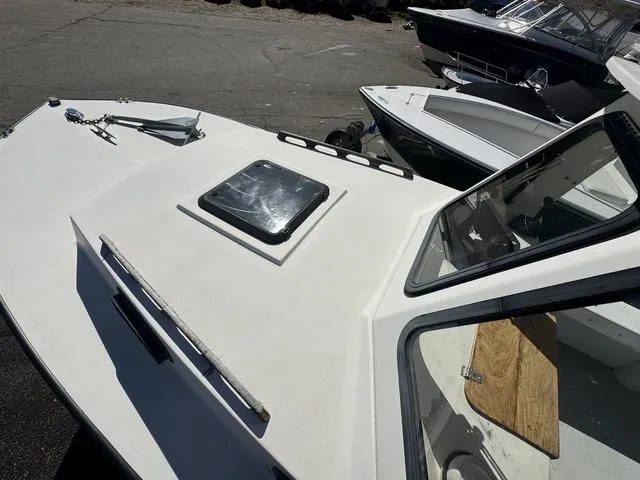 Slide: The Image of 1996 Eastern 27 Lobster Fisherman boat, white deck, docked with other boats. - 10