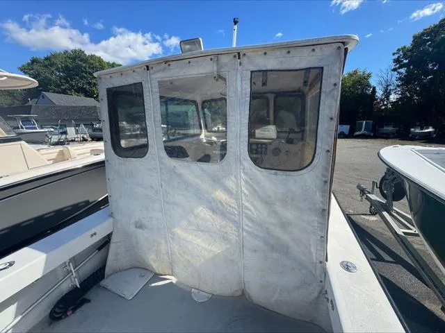 Slide: The Image of 1996 Eastern 27 Lobster Fisherman boat with enclosed cabin, docked outdoors. - 16