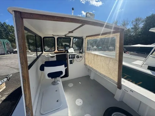 Slide: The Image of 1996 Eastern 27 Lobster Fisherman boat interior with steering wheel and seating. - 18