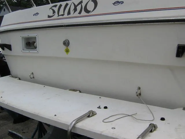 Slide: The Image of 1983 Bayliner 2850 Contessa boat stern with "SUMO" name, white exterior. - 17