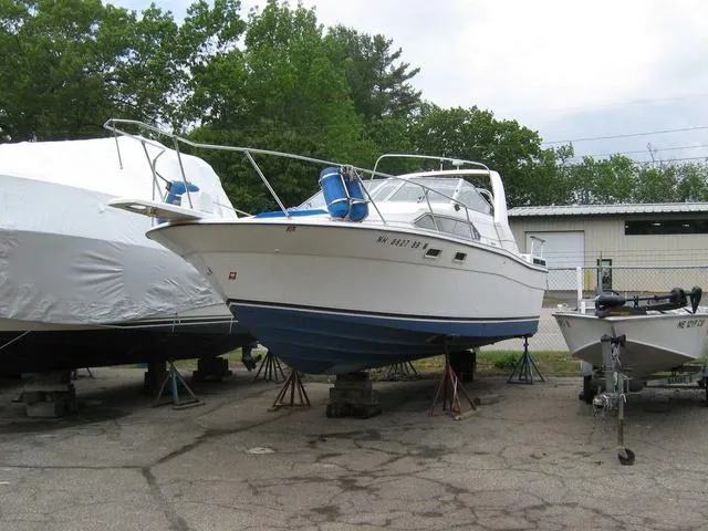 Slide: The Image of 1983 Bayliner 2850 Contessa boat on stands, outdoor storage area. - 20