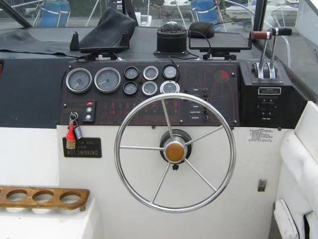 Slide: The Image of 1983 Bayliner 2850 Contessa helm with gauges, steering wheel, and controls. - 3