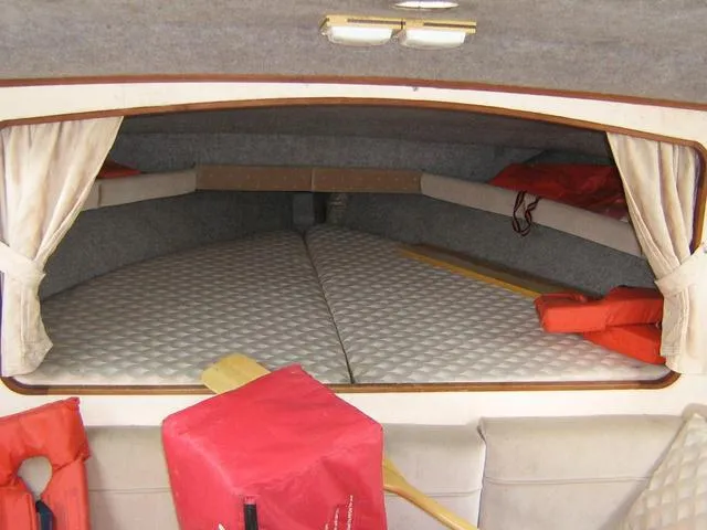 Slide: The Image of Interior cabin of 1983 Bayliner 2850 Contessa with life jackets and cushioned sleeping area. - 4
