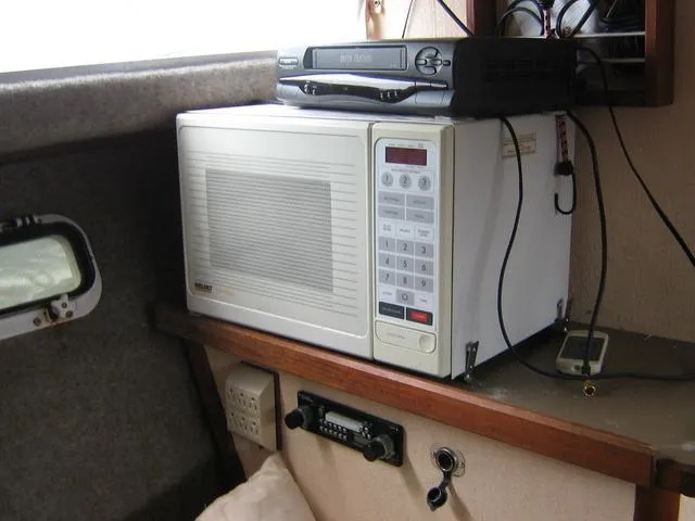 Slide: The Image of Microwave and electronics inside 1983 Bayliner 2850 Contessa boat cabin. - 8