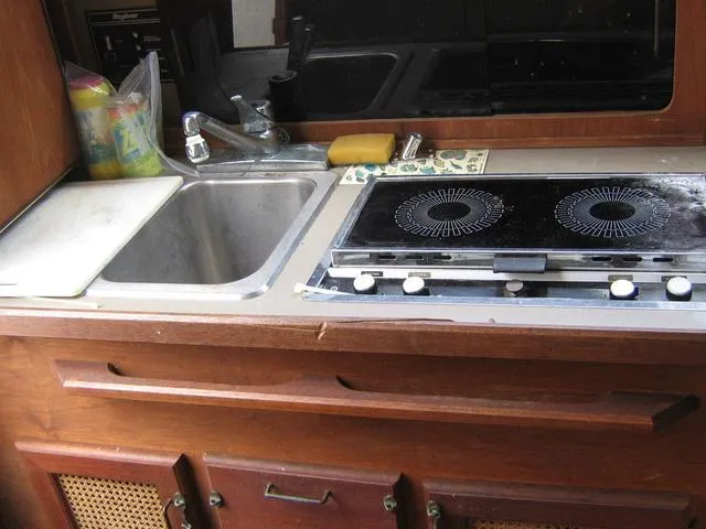 Slide: The Image of 1983 Bayliner 2850 Contessa kitchen with sink and stove. - 9