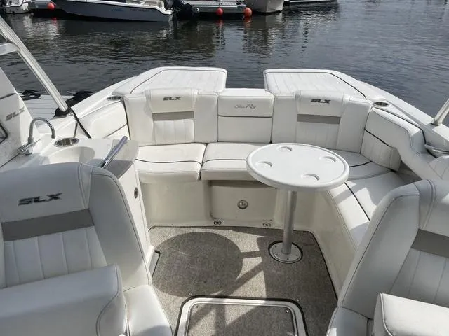 Slide: The Image of 2010 Sea Ray 25 SELECT EX boat interior with white seating and round table. - 3