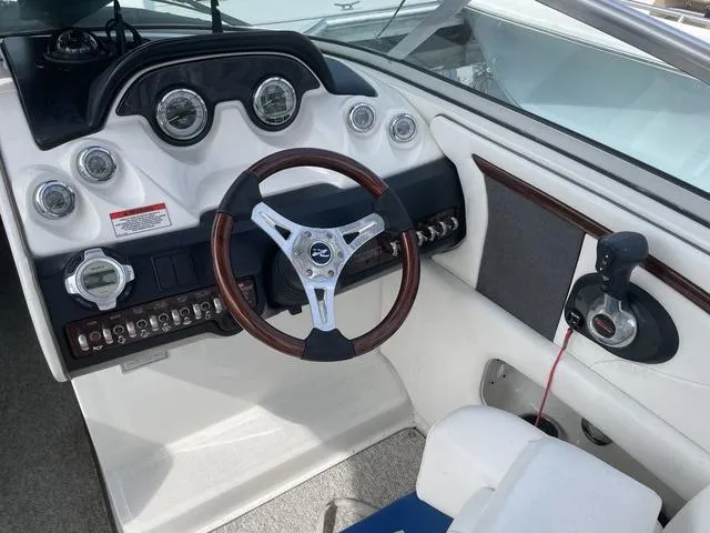 Slide: The Image of 2010 Sea Ray 25 SELECT EX boat dashboard with steering wheel and control panel. - 4