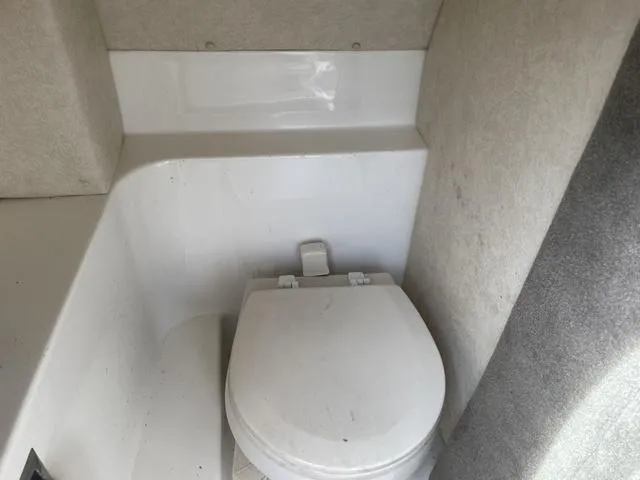 Slide: The Image of Interior view of a 2010 Sea Ray 25 SELECT EX boat bathroom with a white toilet. - 6
