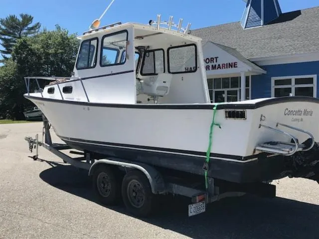 Slide: The Image of 2003 Eastern 27' Lobster boat on trailer outside marine shop. - 10