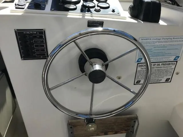 Slide: The Image of Steering wheel of a 2003 Eastern 27' Lobster boat with control panel. - 3