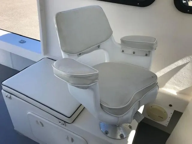 Slide: The Image of White captain's chair on 2003 Eastern 27' Lobster boat, featuring cushioned armrests. - 5