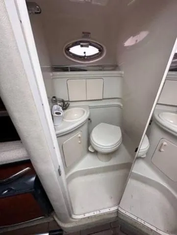 Slide: The Image of 2007 Sea Ray 280 Sundancer boat bathroom with compact sink and toilet. - 12