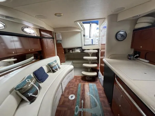 Slide: The Image of Interior of 2003 Sea Ray 340 Sundancer yacht with elegant seating and modern amenities. - 10