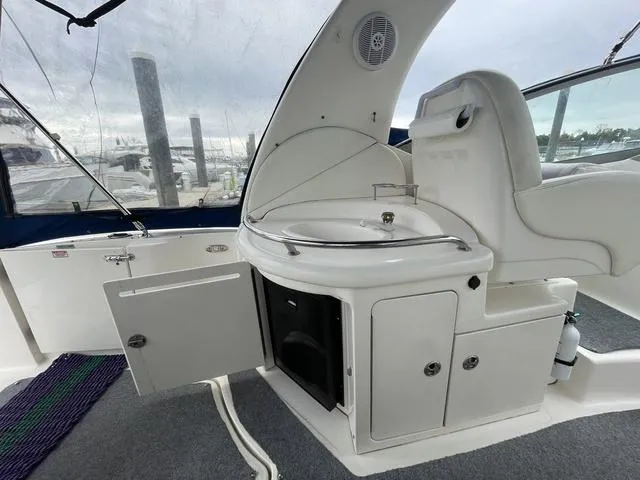 Slide: The Image of 2003 Sea Ray 340 Sundancer cockpit with sink and storage cabinets. - 15