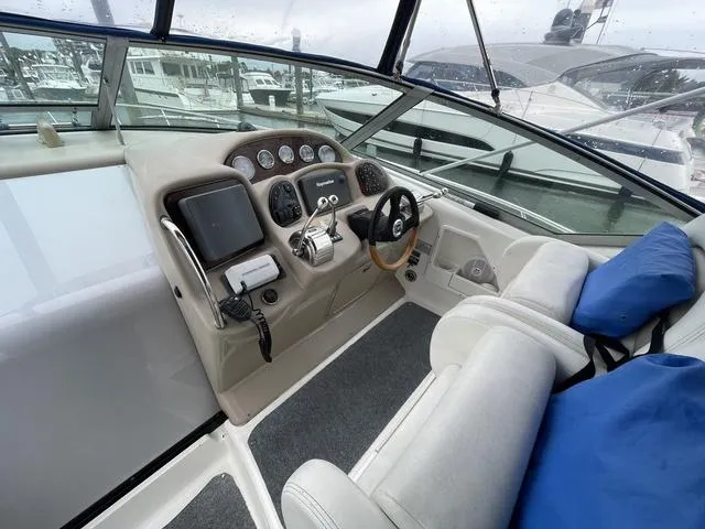 Slide: The Image of 2003 Sea Ray 340 Sundancer helm with modern controls and comfortable seating. - 16