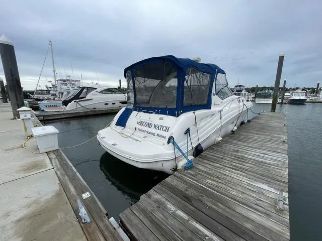 Slide: The Image of 2003 Sea Ray 340 Sundancer docked at a marina with a blue canopy. - 3