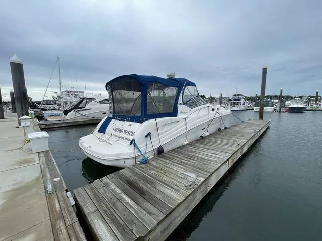 Slide: The Image of 2003 Sea Ray 340 Sundancer docked at marina with blue canopy. - 4