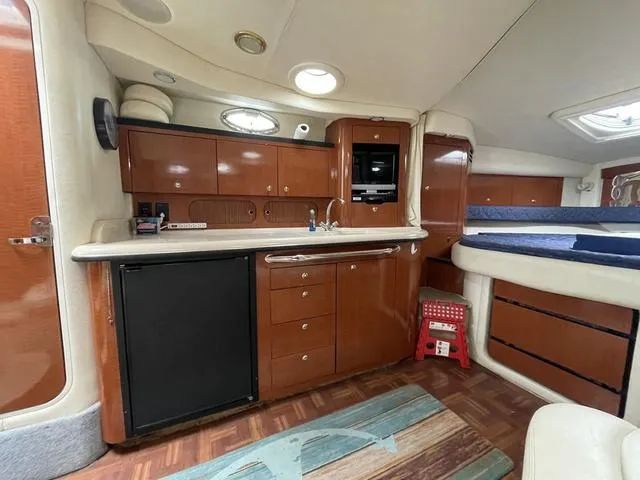 Slide: The Image of 2003 Sea Ray 340 Sundancer cabin interior with kitchenette and sleeping area. - 6