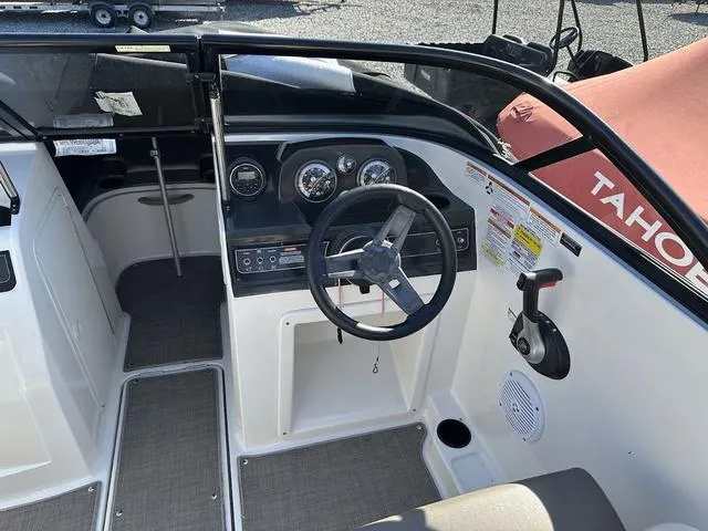 Slide: The Image of 2018 Bayliner VR4 boat cockpit with steering wheel and control panel. - 6