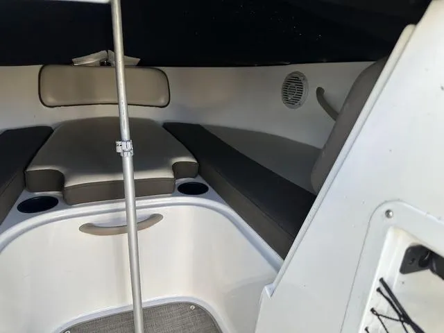 Slide: The Image of 2018 Bayliner VR4 cabin interior with cushioned seating and cup holders. - 8