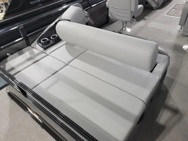 Slide: The Image of 2024 Regency 250 DL3 boat interior with gray seating and cup holders. - 10