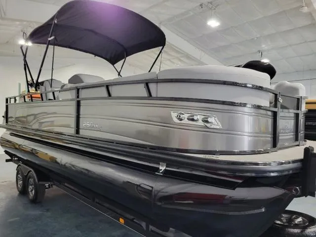 Slide: The Image of 2024 Regency 250 DL3 pontoon boat with canopy in showroom. - 5