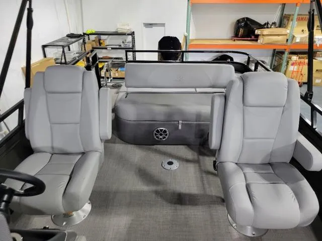 Slide: The Image of 2024 Regency 250 DL3 boat interior with gray seating and storage shelves. - 8