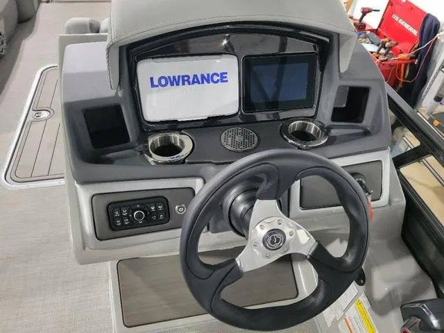 Slide: The Image of 2024 Regency 250 DL3 boat dashboard with Lowrance display and steering wheel. - 9
