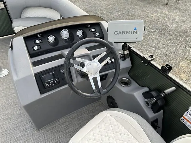 Slide: The Image of 2021 Bennington 22 LFB boat dashboard with Garmin navigation system and steering wheel. - 11