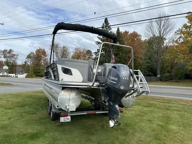 Slide: The Image of 2021 Bennington 22 LFB pontoon boat with Yamaha 115 engine on a grassy area. - 13
