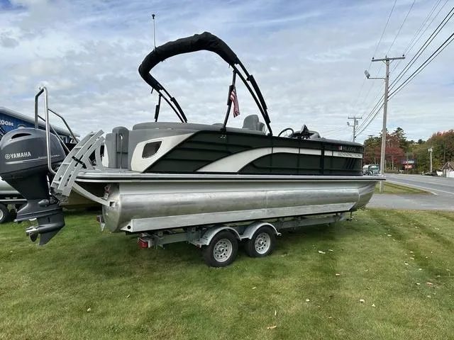 Slide: The Image of 2021 Bennington 22 LFB pontoon boat on trailer, parked on grass. - 14
