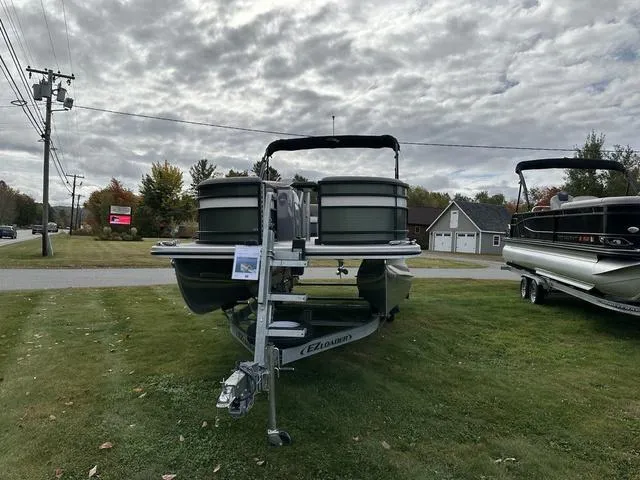 Slide: The Image of 2021 Bennington 22 LFB pontoon boat on trailer, parked on grass under cloudy sky. - 15