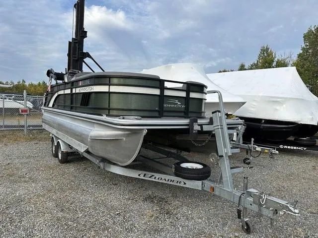 Slide: The Image of 2021 Bennington 22 LFB pontoon boat on trailer in outdoor storage area. - 2