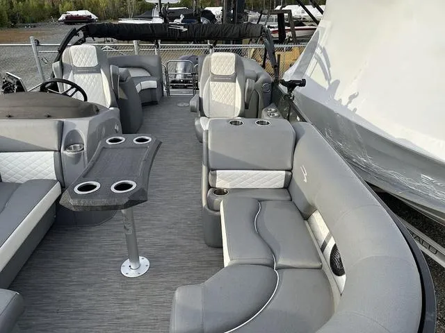 Slide: The Image of 2021 Bennington 22 LFB pontoon boat interior with gray seating and cup holders. - 5