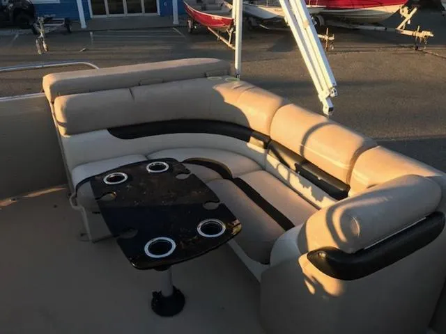 Slide: The Image of 2013 Cypress Cay Seabreeze 180 pontoon boat with beige seating and table. - 10