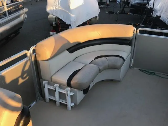 Slide: The Image of 2013 Cypress Cay Seabreeze 180 pontoon boat with beige seating and black accents. - 11