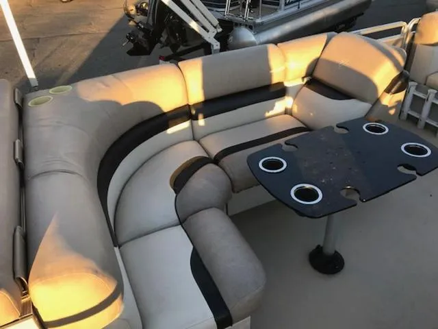 Slide: The Image of 2013 Cypress Cay Seabreeze 180 pontoon boat with beige seating and black table. - 8