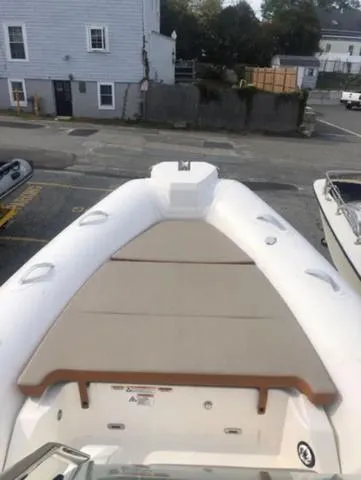 Slide: The Image of 2024 Zodiac Boats Medline 6.8, docked, showcasing spacious deck and seating area. - 12