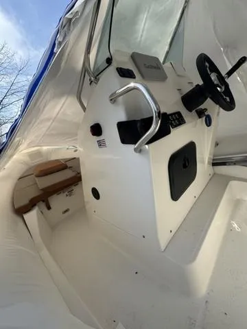 Slide: The Image of 2024 Zodiac Boats Medline 6.8 interior, featuring steering console and seating area. - 3