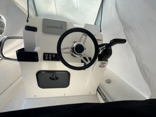 Slide: The Image of 2024 Zodiac Medline 6.8 boat helm with Garmin navigation system. - 6