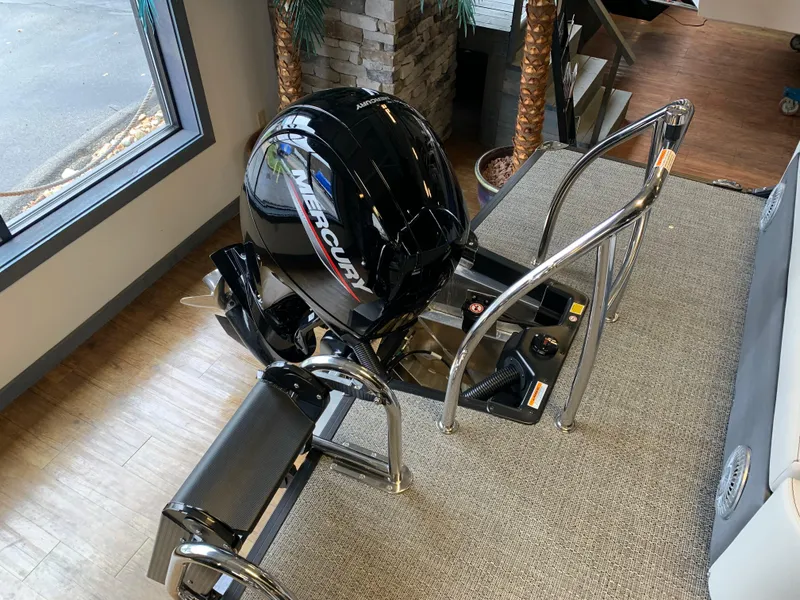 Slide: The Image of 2025 Barletta Cabrio 22U boat with Mercury outboard motor, indoor showroom display. - 10