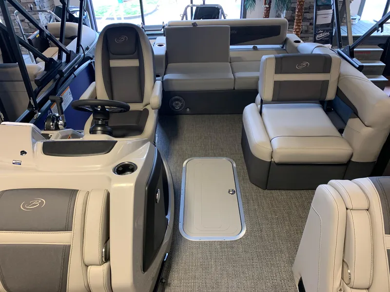 Slide: The Image of 2025 Barletta Cabrio 22U pontoon boat interior with plush seating and modern helm. - 3
