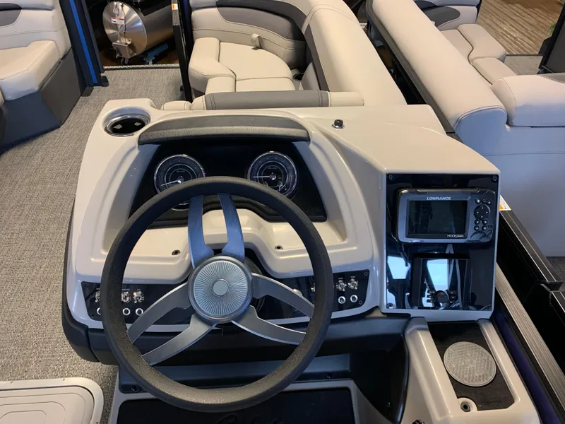 Slide: The Image of 2025 Barletta Cabrio 22U boat dashboard with steering wheel and navigation system. - 5